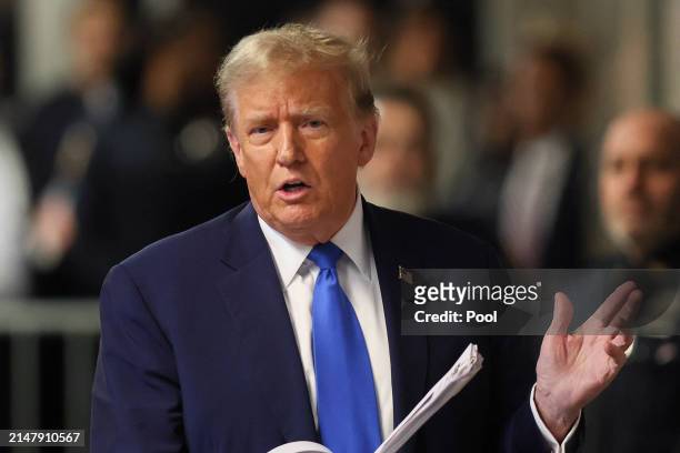Former US President Donald Trump speaks to the media as he leaves court for the day at Manhattan Criminal Court on April 18, 2024 in New York City....