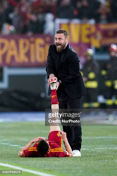 Daniele De Rossi head coach of AS Roma helps Stephan El Shaarawy during the UEFA Europa League 2023/24 Quarter-Final second leg match between AS Roma...