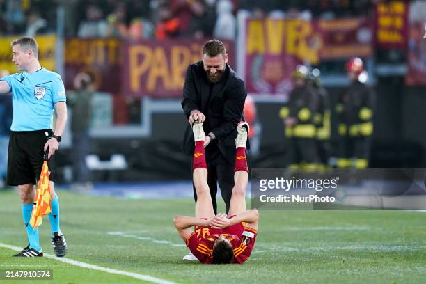 Daniele De Rossi head coach of AS Roma helps Stephan El Shaarawy during the UEFA Europa League 2023/24 Quarter-Final second leg match between AS Roma...