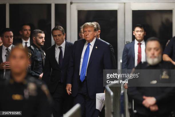 Former US President Donald Trump walks to speak to the media as he leaves court for the day at Manhattan Criminal Court on April 18, 2024 in New York...