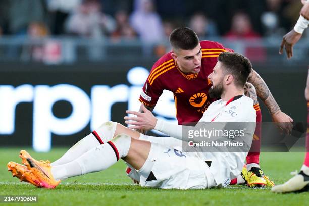 Gianluca Mancini of AS Roma argues with Olivier Giroud of AC Milan during the UEFA Europa League 2023/24 Quarter-Final second leg match between AS...