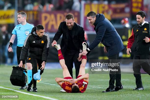 Daniele De Rossi head coach of AS Roma helps Stephan El Shaarawy during the UEFA Europa League 2023/24 Quarter-Final second leg match between AS Roma...