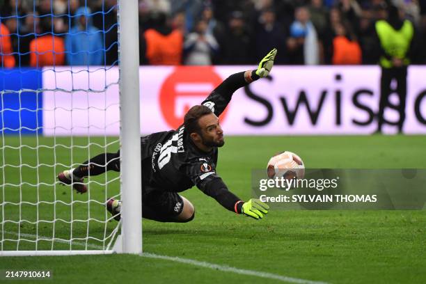 Marseille's Spanish goalkeeper Pau Lopez stops a shot during the penalty shoot out during the UEFA Europa League quarter final second leg football...
