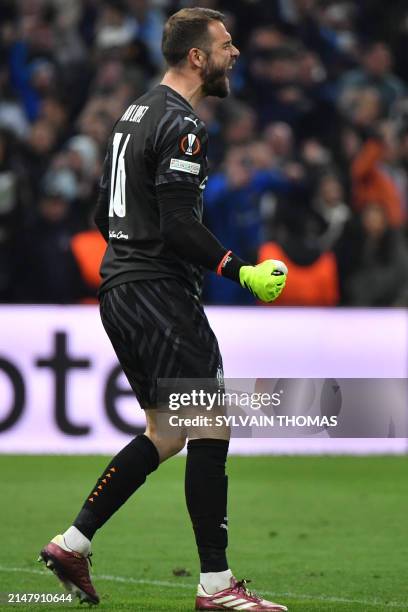 Marseille's Spanish goalkeeper Pau Lopez reacts after stopping a shot during the penalty shoot out during the UEFA Europa League quarter final second...