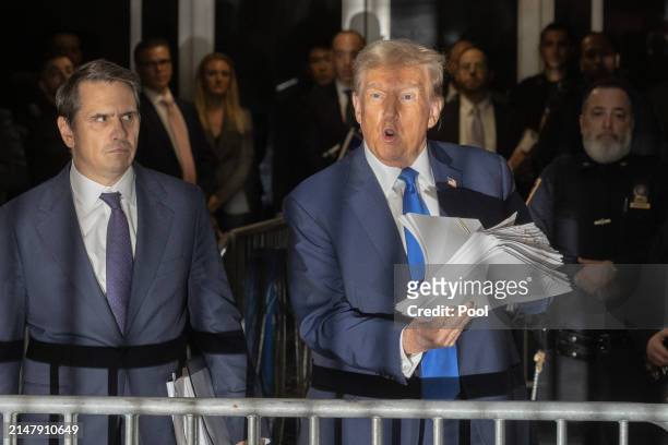 Former U.S. President Donald Trump speaks to members of the media as he departs Manhattan Criminal Court with his attorney Todd Blanche on April 18,...