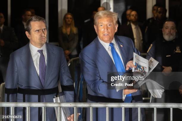 Former U.S. President Donald Trump speaks to members of the media as he departs Manhattan Criminal Court with his attorney Todd Blanche on April 18,...