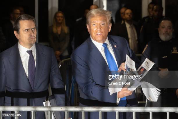 Former U.S. President Donald Trump speaks to members of the media as he departs Manhattan Criminal Court with his attorney Todd Blanche on April 18,...