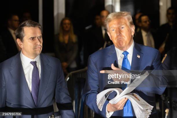 Former U.S. President Donald Trump speaks to members of the media as he departs Manhattan Criminal Court with his attorney Todd Blanche on April 18,...