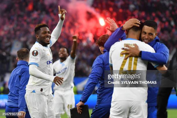 Marseille's Cameroonian forward Faris Moumbagna and teammates celebrate at the end of the penalty shootouts and winning the UEFA Europa League...