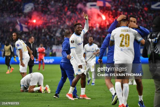 Marseille's Cameroonian forward Faris Moumbagna and teammates celebrate at the end of the penalty shootouts and after winning the UEFA Europa League...