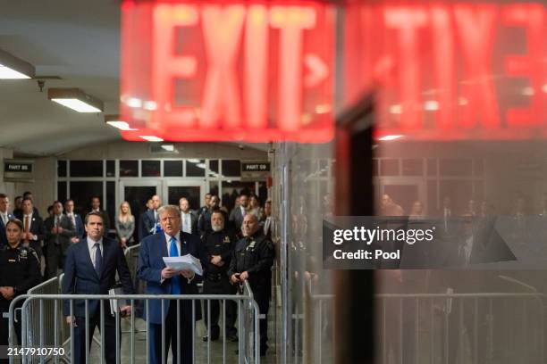 Former U.S. President Donald Trump speaks to members of the media as he departs Manhattan Criminal Court with his attorney Todd Blanche on April 18,...