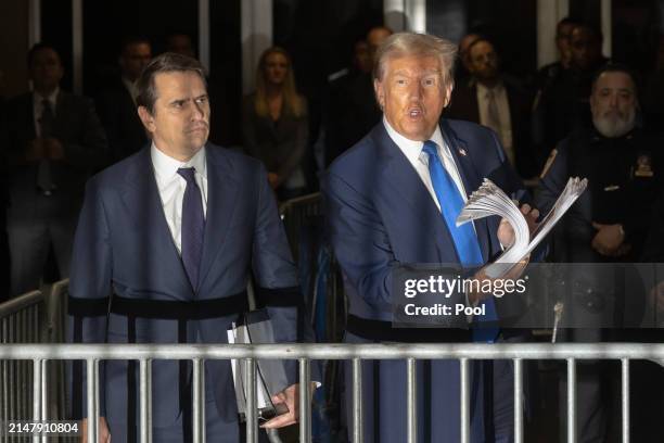 Former U.S. President Donald Trump speaks to members of the media as he departs Manhattan Criminal Court with his attorney Todd Blanche on April 18,...