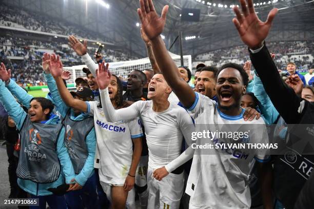 Marseille's Moroccan French midfielder Amine Harit and teammates celebrate after winning the UEFA Europa League quarter final second leg football...