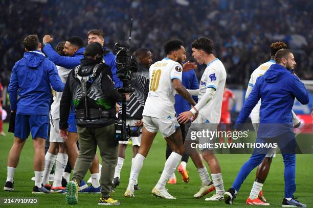 Marseille's French-Gabonese forward Pierre-Emerick Aubameyang C-L) and Marseille's Italian Argentinian defender Leonardo Balerdi celebrate after...