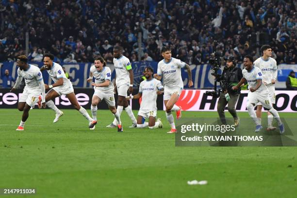 Marseille players celebrate after winning the UEFA Europa League quarter final second leg football match between Olympique de Marseille and SL...