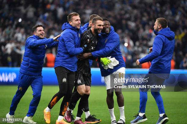 Marseille's Spanish goalkeeper Pau Lopez celebrate with teammater after winning the UEFA Europa League quarter final second leg football match...