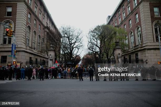 Officers stand near barriers as pro-Palestinian protesters gather outside of Columbia University in New York City on April 18, 2024. Officers cleared...