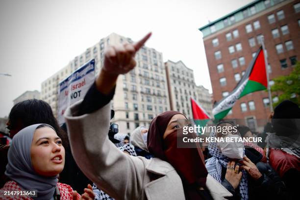 Pro-Palestinian protesters march outside Columbia University in New York City on April 18, 2024. Officers cleared out a pro-Palestinian campus...