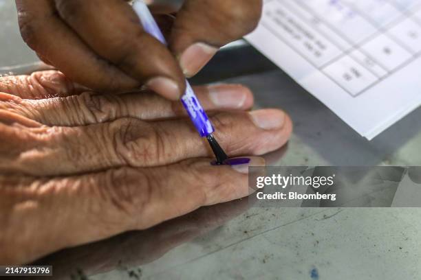 Voter's finger is marked with indelible ink after casting a ballot at a polling station during the first phase of voting for national elections in...