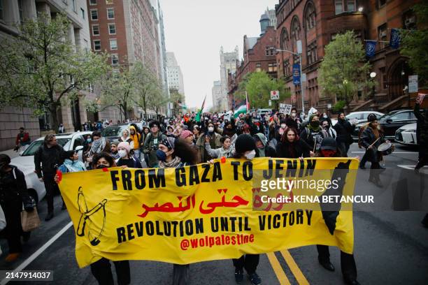 Pro-Palestinian protesters march outside Columbia University in New York City on April 18, 2024. Officers cleared out a pro-Palestinian campus...