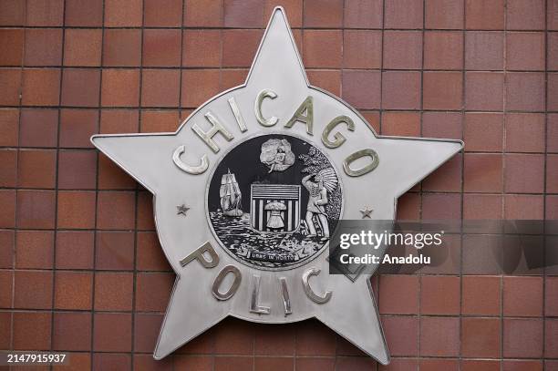 Protesters hold signs outside Chicago police headquarters, joining Dexter Reed's demonstration against police brutality and discrimination in...