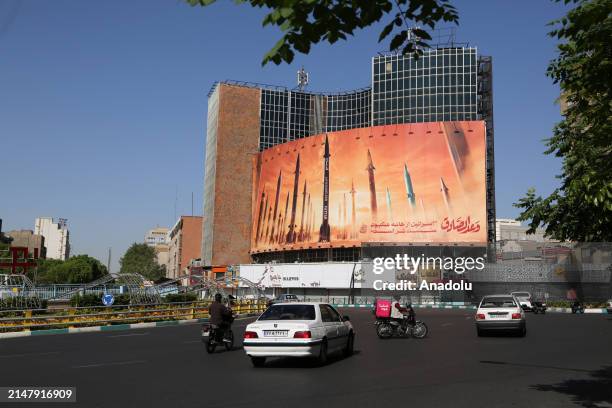 Vehicles pass the streets of Tehran as they continue their daily lives after the explosions heard in Isfahan and Tabriz cities of Iran, in Tehran,...