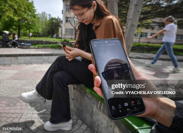 Girl shows a mobile phone where Tik Tok reports problems to be accessed, in Bishkek on April 19, 2024. The ban in Kyrgyzstan -- a small, ex-Soviet...