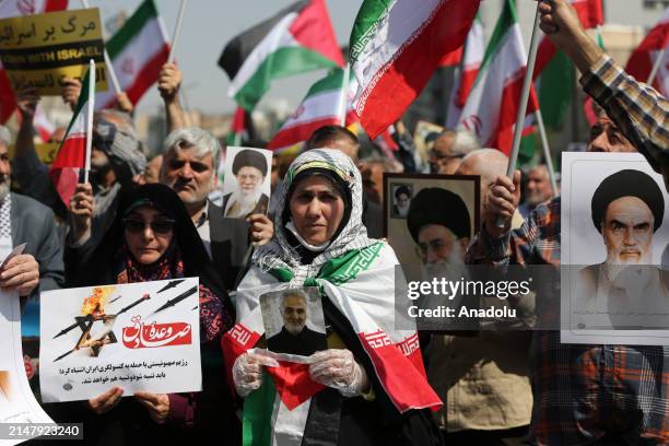 People march with flags and banners to celebrate Iran's April 13 attack on Israel and protest Israel, which is accused of carrying out the attack...