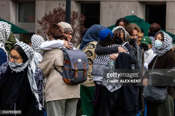 Students hug each other as they occupy the campus ground of Columbia University in support of Palestinians, in New York City, on April 19, 2024....