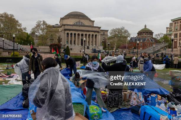 Pro-Palestinian students and activists prepare for rain as they camp out on the campus of Columbia University in New York City on April 19, 2024....