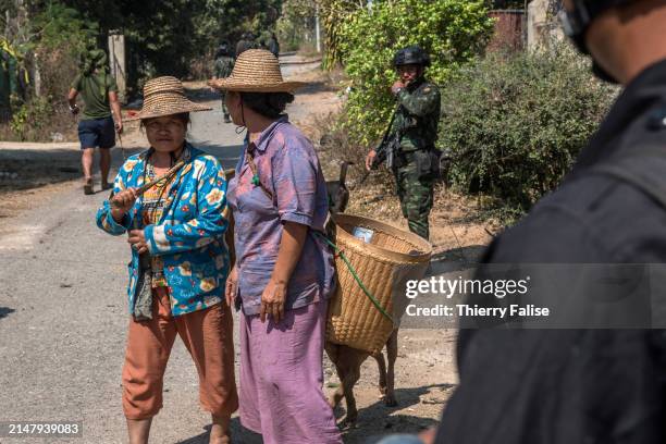 Two women have come to pick up personal effects in their abandoned home in Loikaw that was partly seized by he Karenni Nationalities Defence Force...