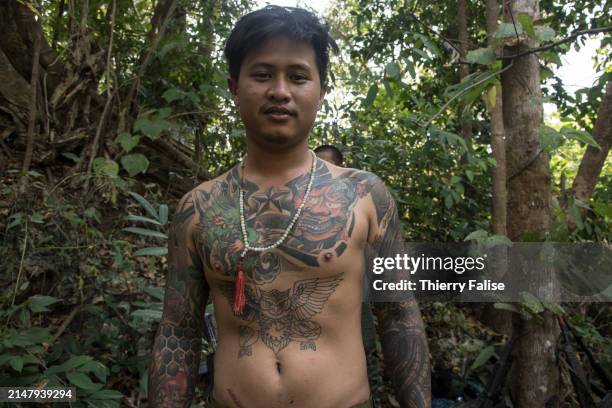 Kndf A soldier from the Karenni Nationalities Defence Force shows tattoos ...