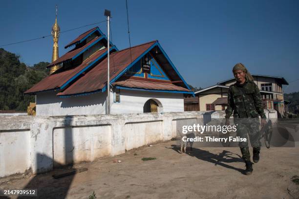 Soldier from the Karenni Nationalities Defence Force walks past a Buddhist pagoda in a Pa-o ethnic village that has traditionally been under control...