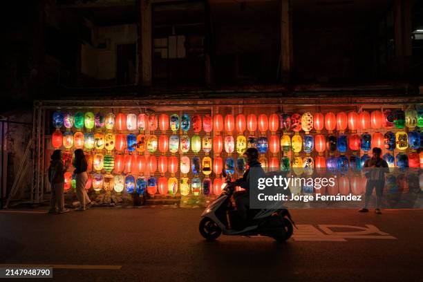 Night falls as vibrant lanterns light up the streets of Tainan.
