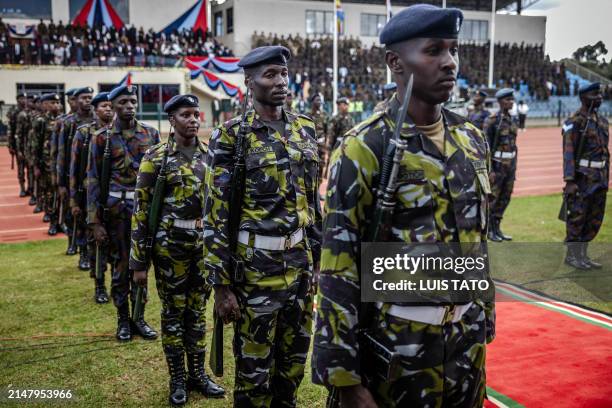 Members of the Kenyan Army stand in formation during a military honours ceremony in memory of the defence chief and nine other senior top military...