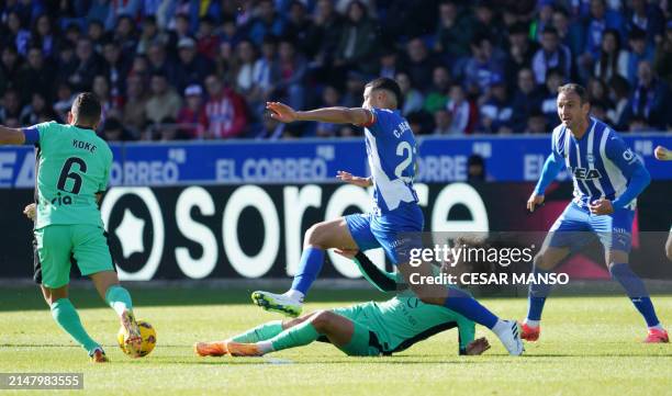 Alaves' Uruguayan midfielder Carlos Benavidez and Atletico Madrid's French forward Antoine Griezmann vie for the ball during the Spanish league...