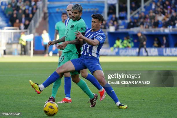 Atletico Madrid's Argentinian forward Angel Correa and Alaves' Spanish defender Antonio Blanco vie for the ball during the Spanish league football...