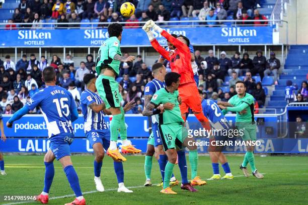 Alaves' Spanish goalkeeper Antonio Sivera jumps to clear the ball during the Spanish league football match between Deportivo Alaves and Club Atletico...