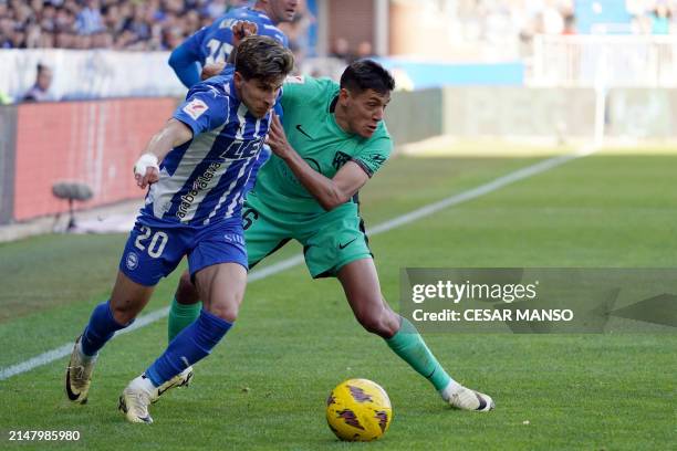 Alaves' Argentine forward Giuliano Simeone and Atletico Madrid's Argentine defender Nahuel Molina vie for the ball during the Spanish league football...