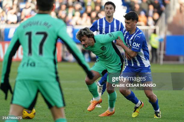Atletico Madrid's French forward Antoine Griezmann and Alaves' Spanish defender Antonio Blanco vie for the ball during the Spanish league football...