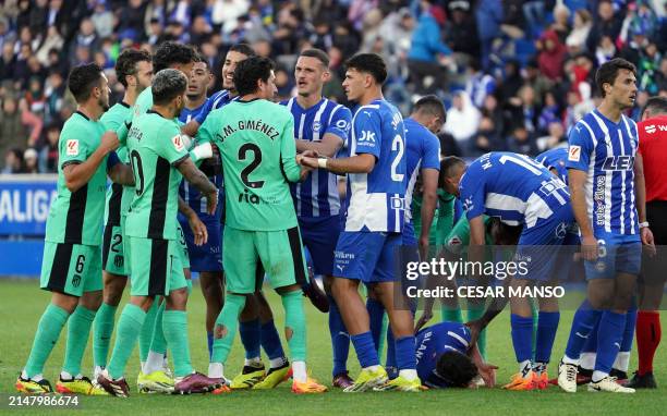 Both teams' players quarrell as Alaves' Spanish defender Antonio Blanco lies on the field during the Spanish league football match between Deportivo...