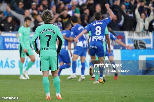 Atletico Madrid's French forward Antoine Griezmann reacts to Alaves' second goal during the Spanish league football match between Deportivo Alaves...