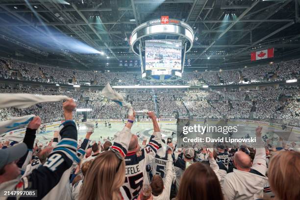 Winnipeg Jets fans cheer on their team as they battle the Colorado Avalanche in Game One of the First Round of the 2024 Stanley Cup Playoffs at...