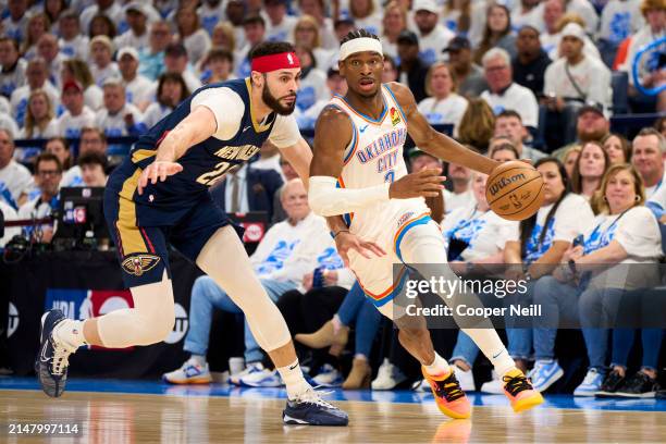 Shai Gilgeous-Alexander of the Oklahoma City Thunder brings the ball up court against the New Orleans Pelicans during the first half in game one of...