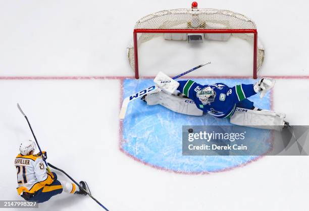 Thatcher Demko of the Vancouver Canucks makes a save on Anthony Beauvillier of the Nashville Predators during the first period in Game One of the...