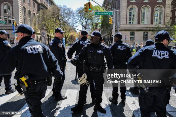 Police officers stand in front of the entrance of Columbia University which is occupied by pro-Palestine protesters in New York on April 22, 2024. US...