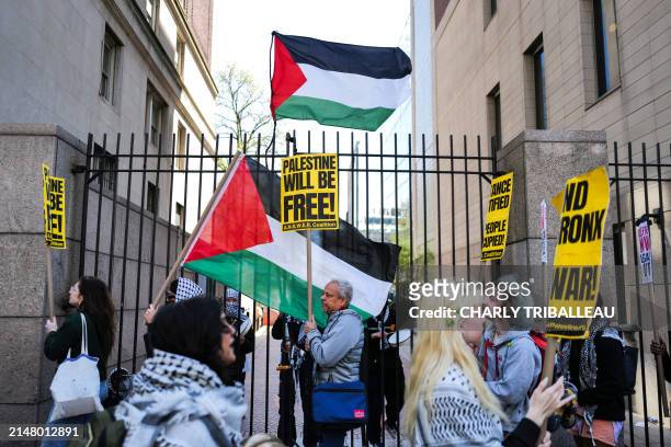 Pro-Palestinian supporters wave flags in front of the entrance of Columbia University which is occupied by pro-Palestine protesters in New York on...
