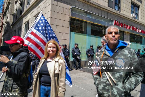 Pro-israel supporters carry flags in front of the entrance of Columbia University which is occupied by pro-Palestinian protesters in New York on...