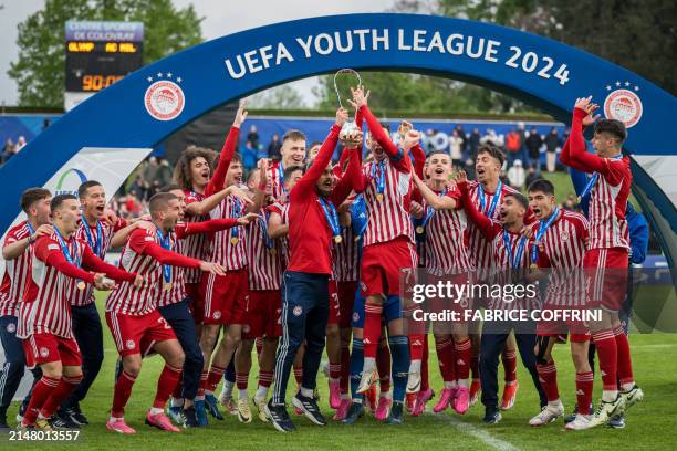 Olympiacos' players celebrate with the trophy after wining the UEFA Youth League final fooball match between Olympiacos and AC Milan at Colovray...