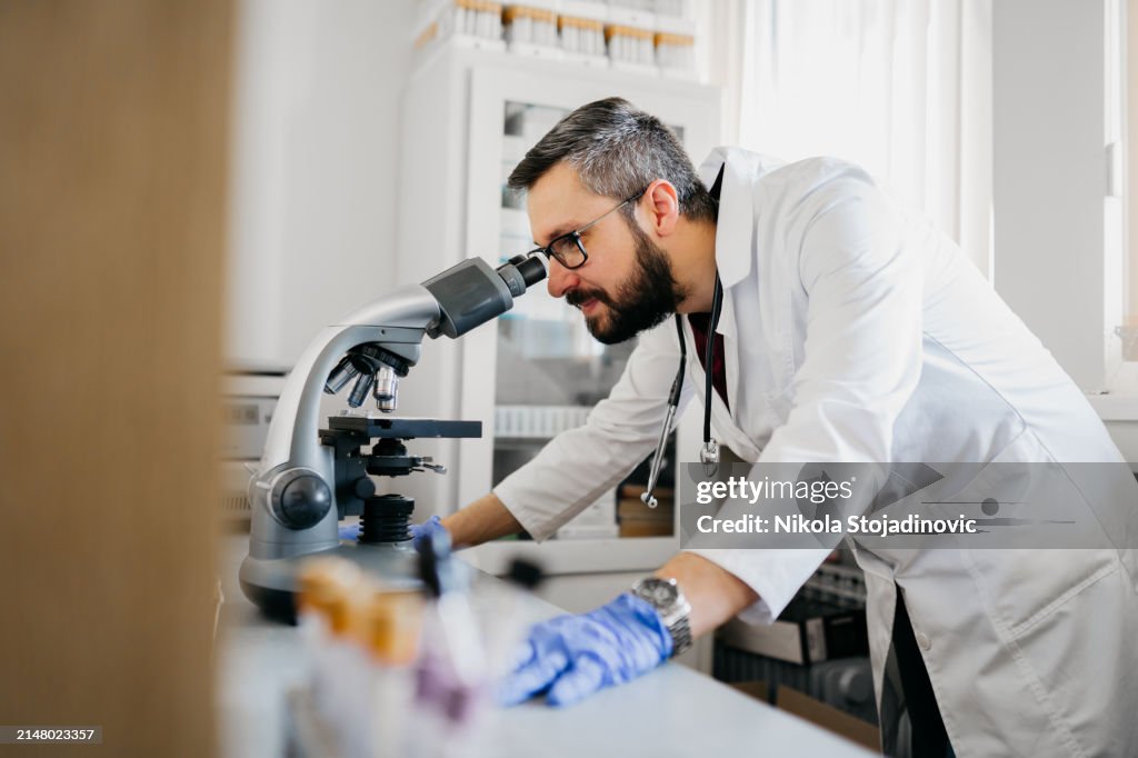 Hübscher Labortechniker mit Teleskop